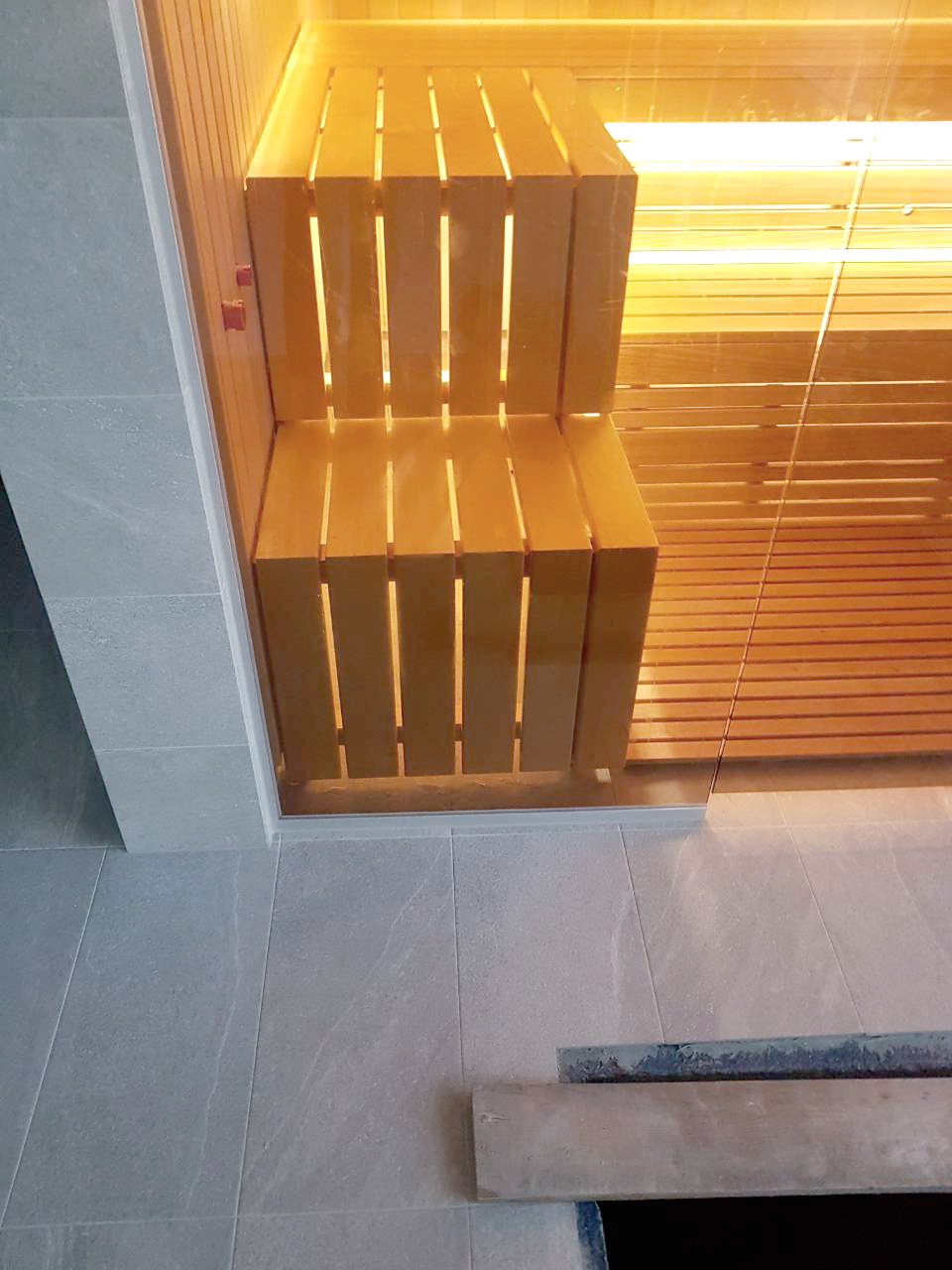 Sauna met glazen wanden en uitzicht op het zwembad